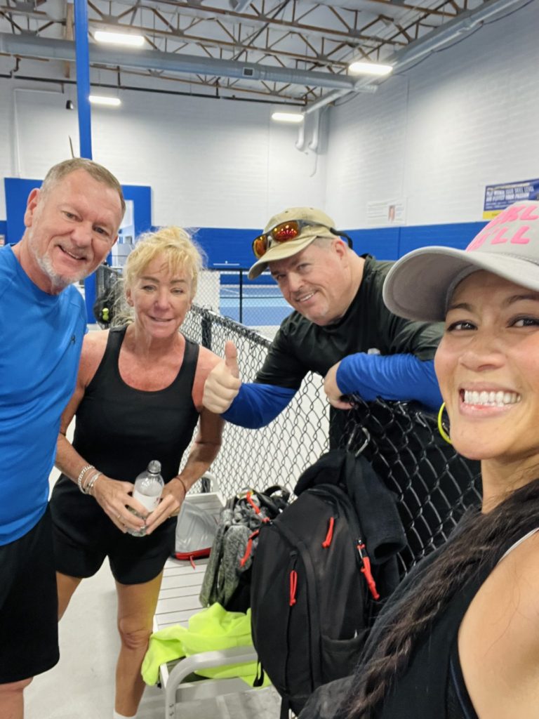 Christine Lozada playing pickleball with both locals and travelers at Pickleball Kingdom