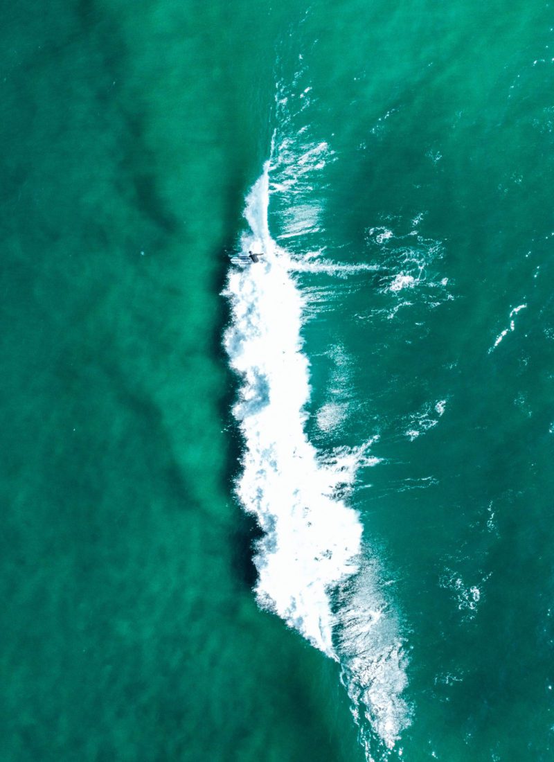 Drone photo of surfer in the waves in California